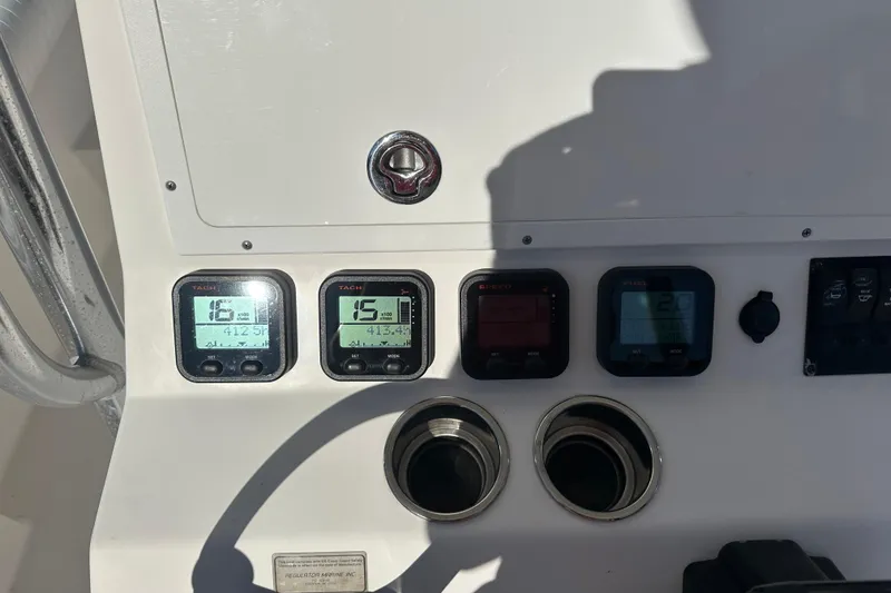 Slide: The Image of Control panel of a 2008 Regulator 26 Forward Seating boat with digital displays. - 15