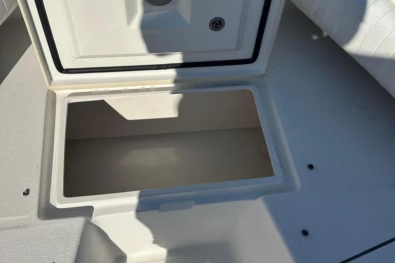 Slide: The Image of Open storage compartment on a 2008 Regulator 26 Forward Seating boat. - 17