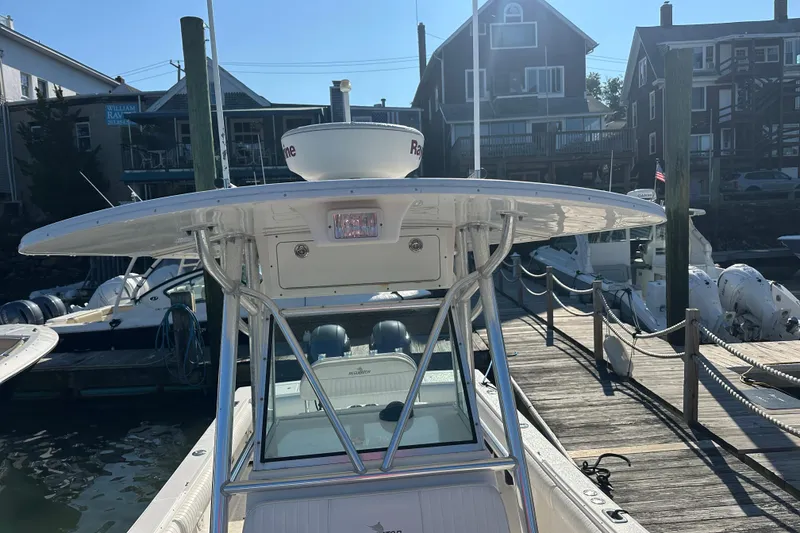 Slide: The Image of 2008 Regulator 26 Forward Seating boat docked at a marina, sunny day. - 4