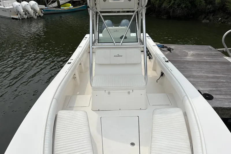 Slide: The Image of 2008 Regulator 26 Forward Seating boat docked by the water. - 6