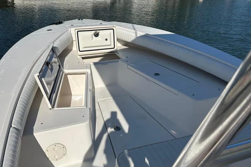 Slide: The Image of 2008 Regulator 26 Forward Seating boat interior with open storage compartments. - 7