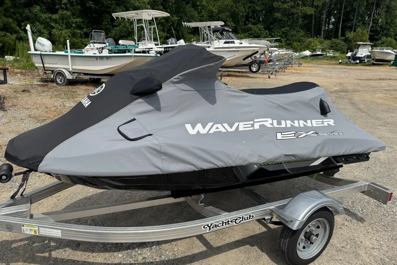 Slide: The Image of 2020 Yamaha WaveRunner EX Deluxe covered on trailer, parked in a boatyard. - 1