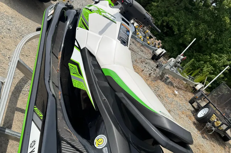 Slide: The Image of 2020 Yamaha WaveRunner EX Deluxe in green and white, parked outdoors on gravel. - 4