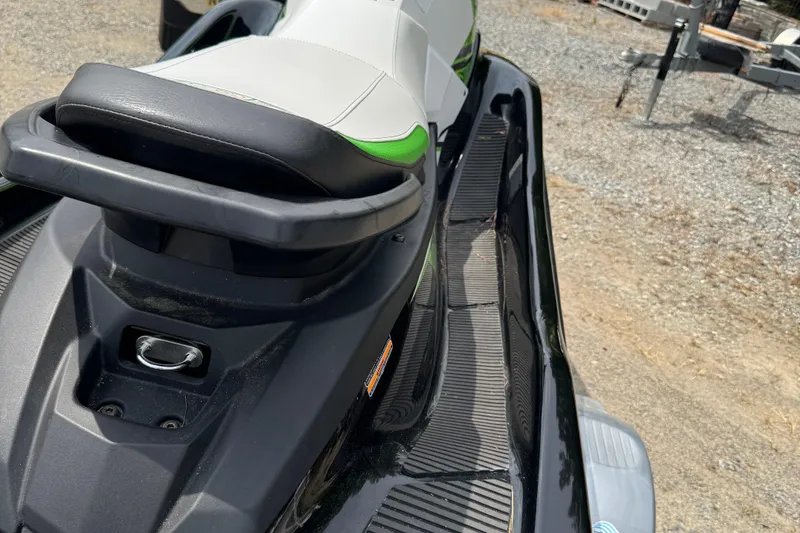 Slide: The Image of 2020 Yamaha WaveRunner EX Deluxe, black and green, parked on gravel. - 6