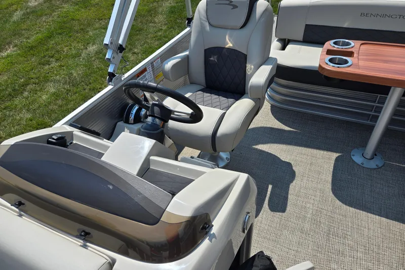 Slide: The Image of 2019 Bennington SX 22 Premium Cruise boat interior with steering wheel and seating. - 12