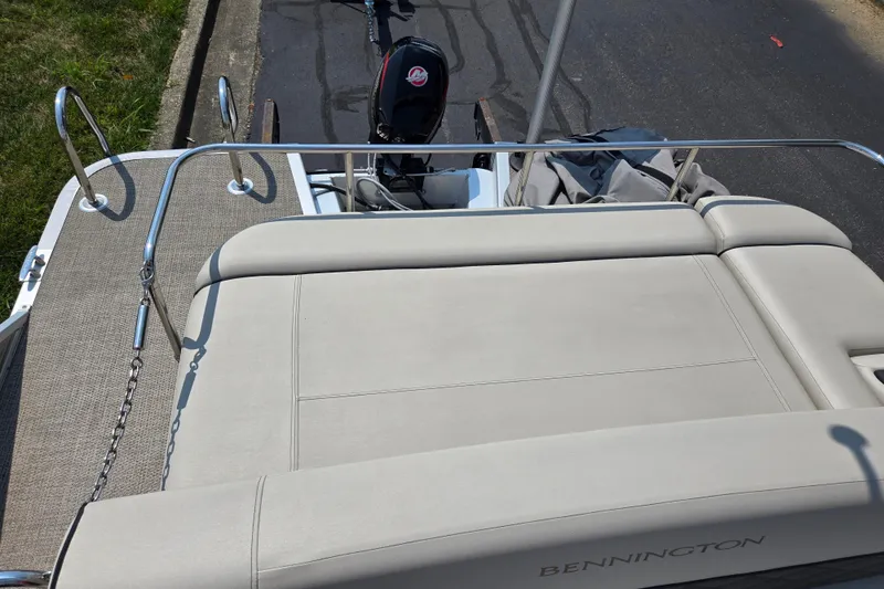 Slide: The Image of 2019 Bennington SX 22 Premium Cruise boat with beige seating and Mercury outboard motor. - 14