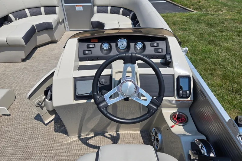 Slide: The Image of 2019 Bennington SX 22 Premium Cruise boat dashboard with steering wheel and control panel. - 19
