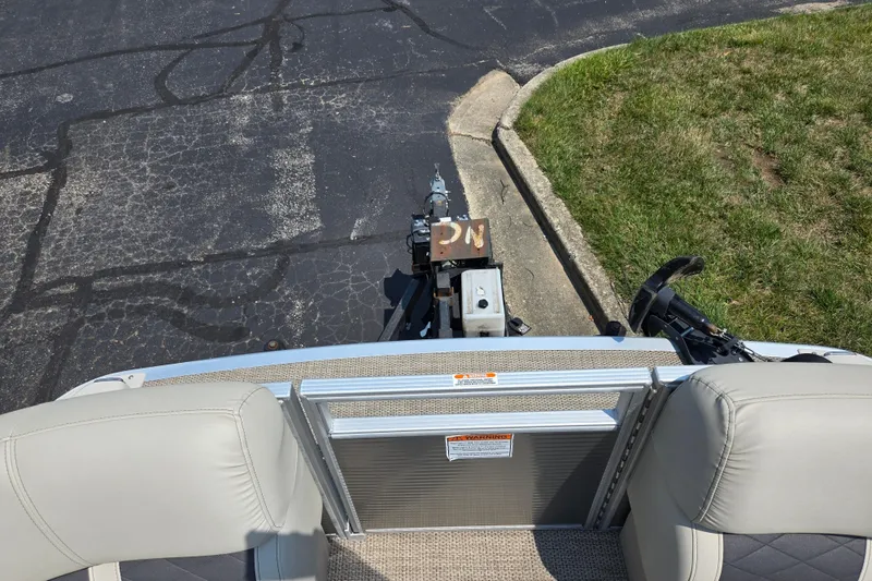 Slide: The Image of 2019 Bennington SX 22 Premium Cruise boat on trailer, parked on asphalt near grass. - 24