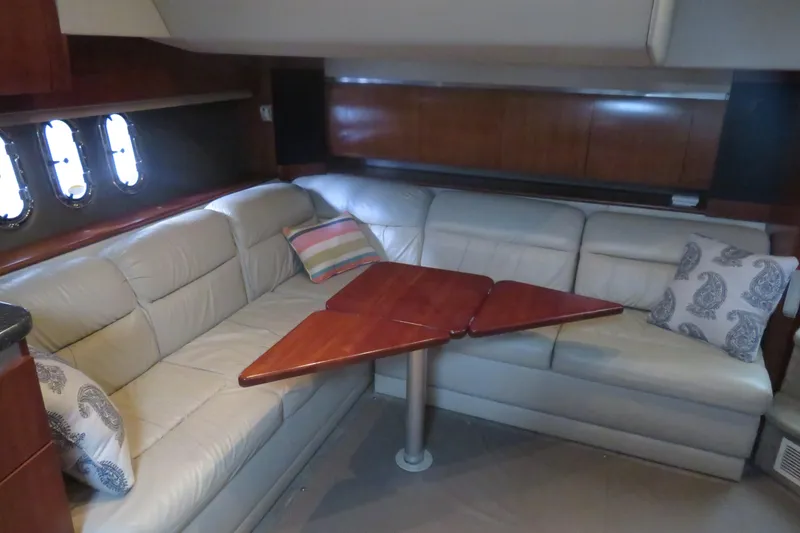 Slide: The Image of Luxurious interior of 2007 Cruisers Yachts 420 Express with leather seating and wooden table. - 11