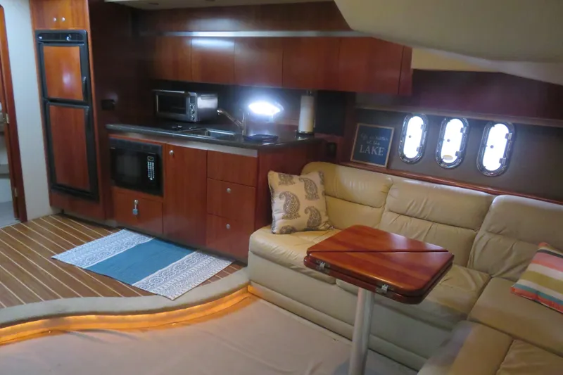 Slide: The Image of Luxurious 2007 Cruisers Yachts 420 Express interior with kitchenette and cozy seating area. - 13