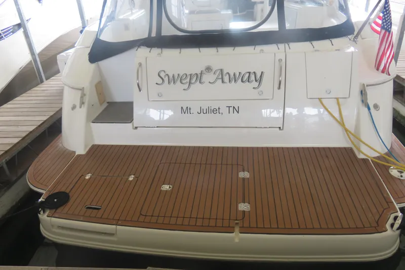 Slide: The Image of 2007 Cruisers Yachts 420 Express docked, featuring teak deck and "Swept Away" nameplate. - 20