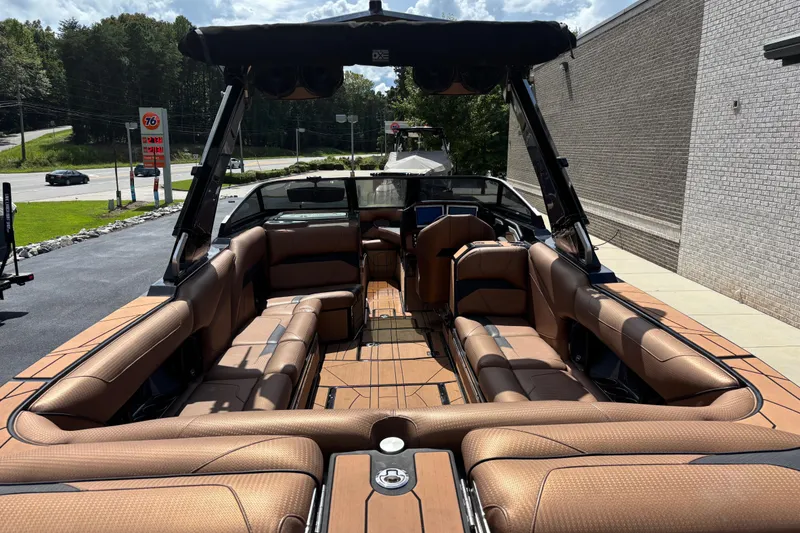 Slide: The Image of 2021 Centurion Ri265 boat interior with luxurious brown seating and sleek design. - 5