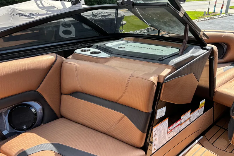 Slide: The Image of 2021 Centurion Ri265 boat interior with tan seating and cup holders. - 9