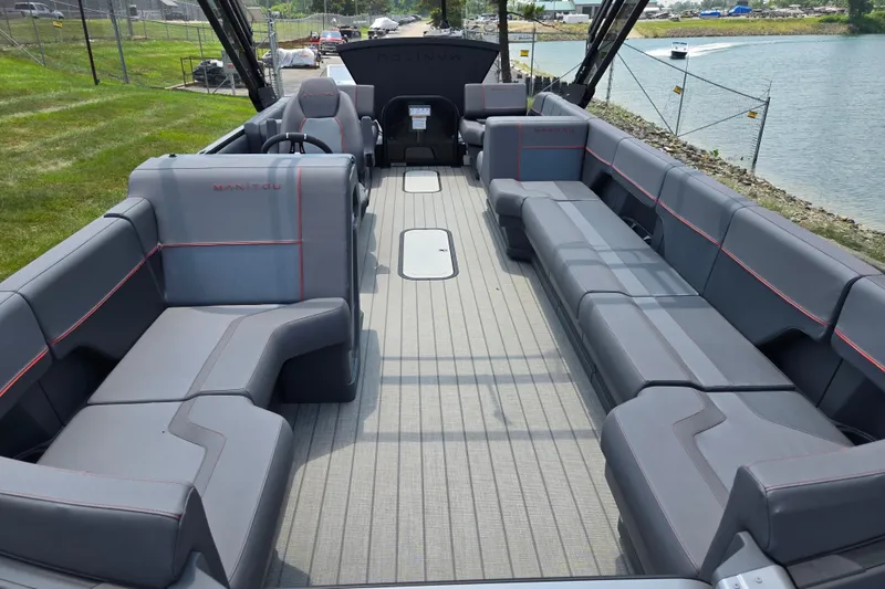 Slide: The Image of 2024 Manitou Explore boat interior with spacious seating and modern design. - 11