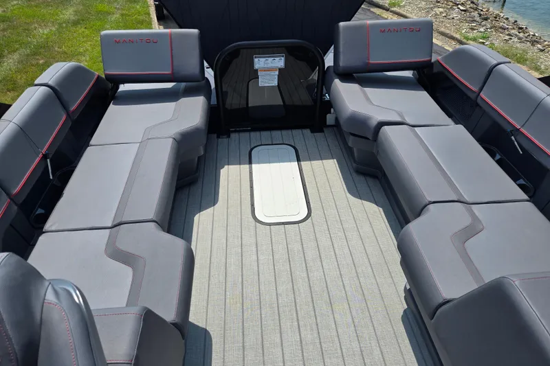 Slide: The Image of 2024 Manitou Explore boat interior with spacious seating and modern design. - 14