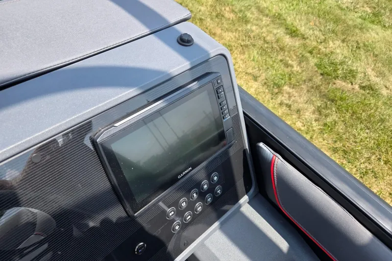 Slide: The Image of 2024 Manitou Explore dashboard featuring a Garmin display and control panel. - 19