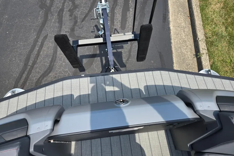 Slide: The Image of 2024 Manitou Explore boat on trailer, viewed from above, showing deck and seating. - 21