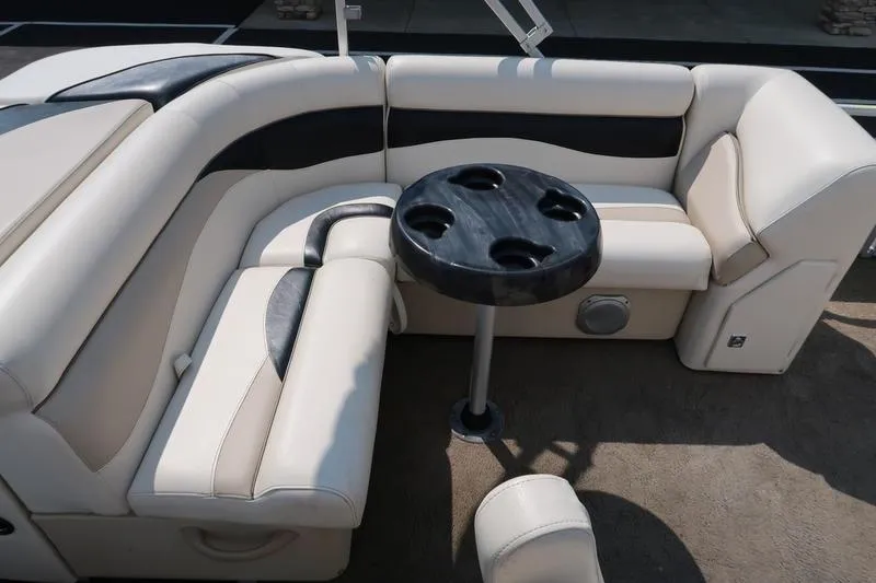 Slide: The Image of Luxurious seating area on a 2012 Sweetwater 200 Classic boat with a round table. - 10
