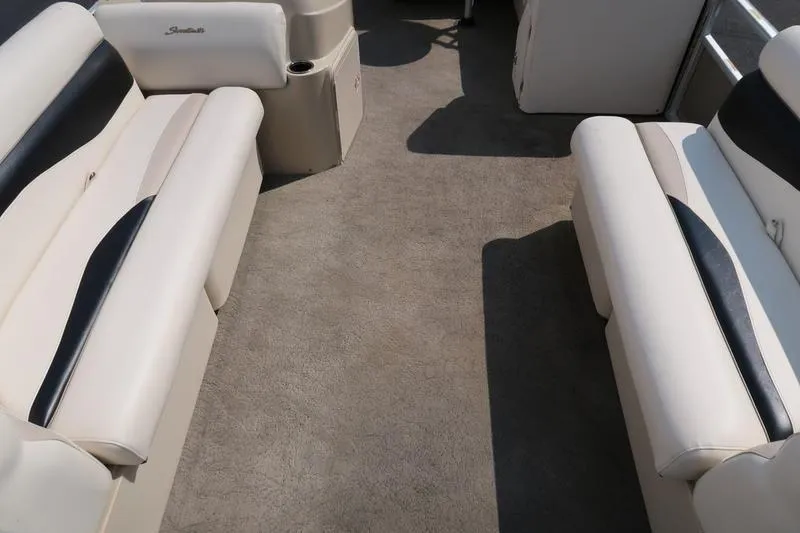 Slide: The Image of Interior of 2012 Sweetwater 200 Classic boat with beige seating and carpet. - 14
