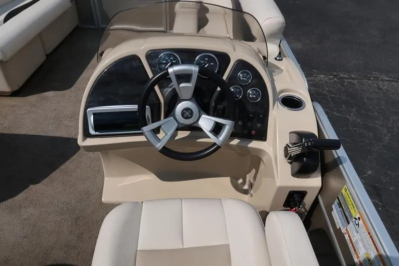 Slide: The Image of 2012 Sweetwater 200 Classic boat dashboard with steering wheel and controls. - 15
