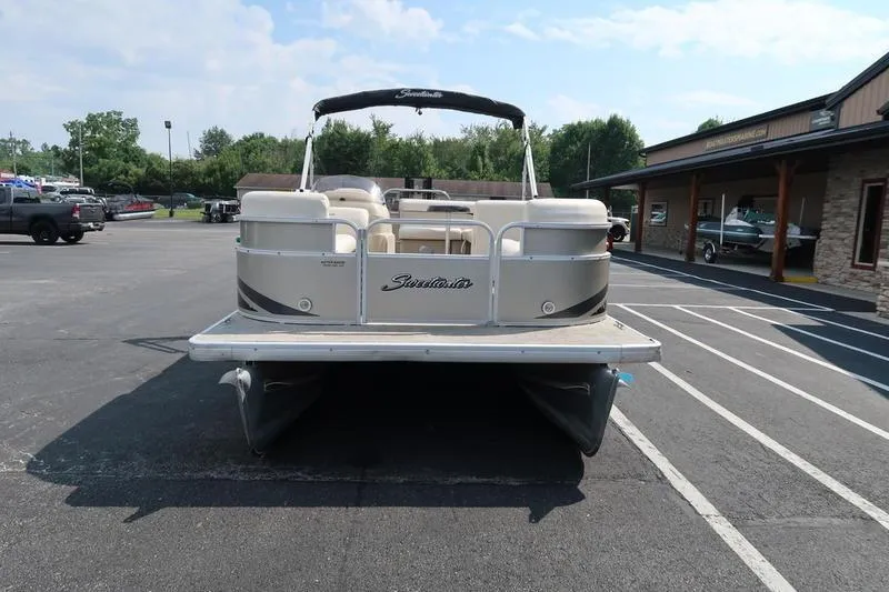 Slide: The Image of 2012 Sweetwater 200 Classic pontoon boat parked in a lot, rear view. - 3