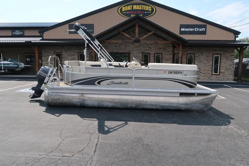 Slide: The Image of 2012 Sweetwater 200 Classic pontoon boat parked outside dealership. - 5