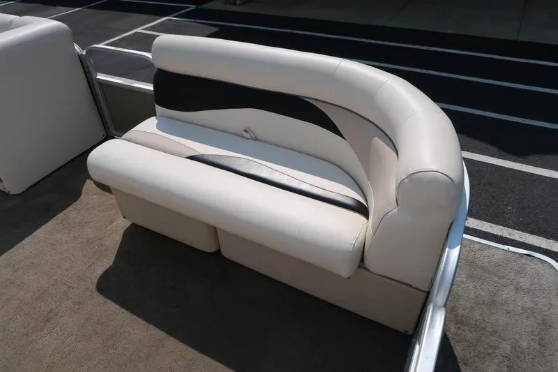 Slide: The Image of Cream and black seating on 2012 Sweetwater 200 Classic boat, outdoor setting. - 9