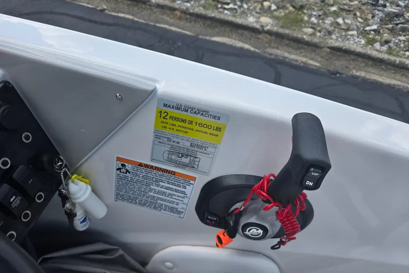 Slide: The Image of 2024 Starcraft SVX 191 OB boat control panel with capacity warning label. - 11