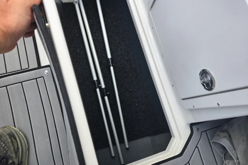 Slide: The Image of 2024 Starcraft SVX 191 OB boat storage compartment with metal poles inside. - 13