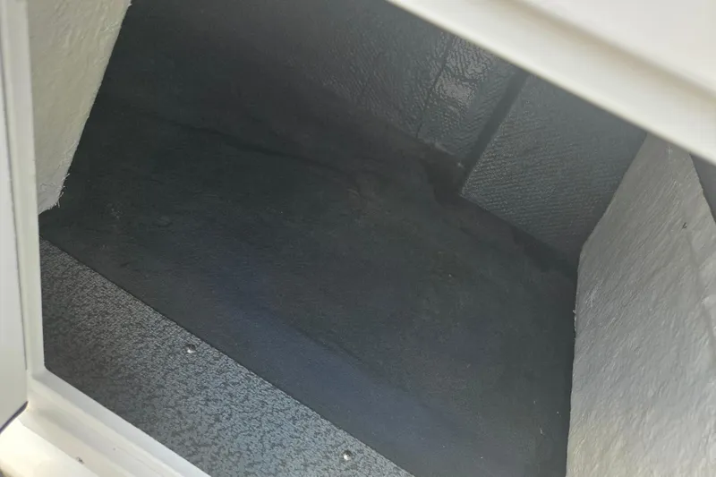 Slide: The Image of Interior compartment of 2024 Starcraft SVX 191 OB boat, showing storage space. - 14