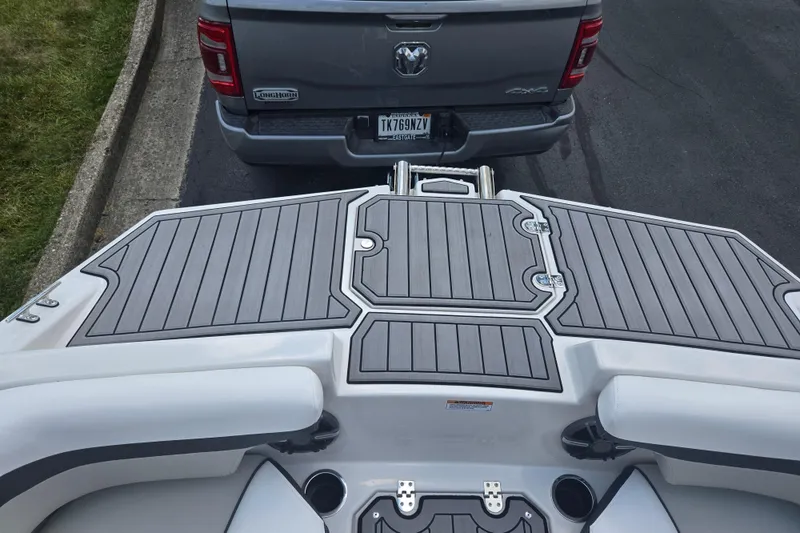 Slide: The Image of 2024 Starcraft SVX 191 OB boat on trailer, parked behind a gray truck. - 16