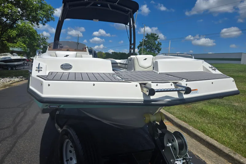 Slide: The Image of 2024 Starcraft SVX 191 OB boat on trailer, under clear blue sky. - 6