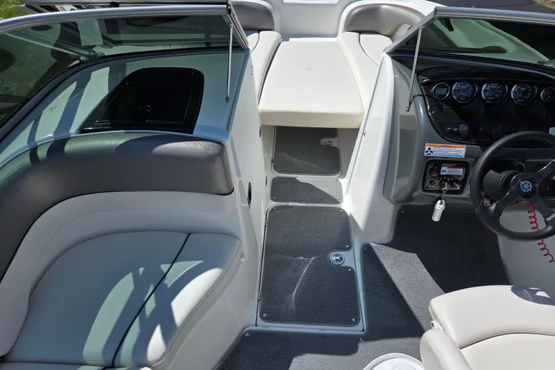 Slide: The Image of 2011 Yamaha Boats AR210 interior with steering wheel, seating, and dashboard controls. - 11