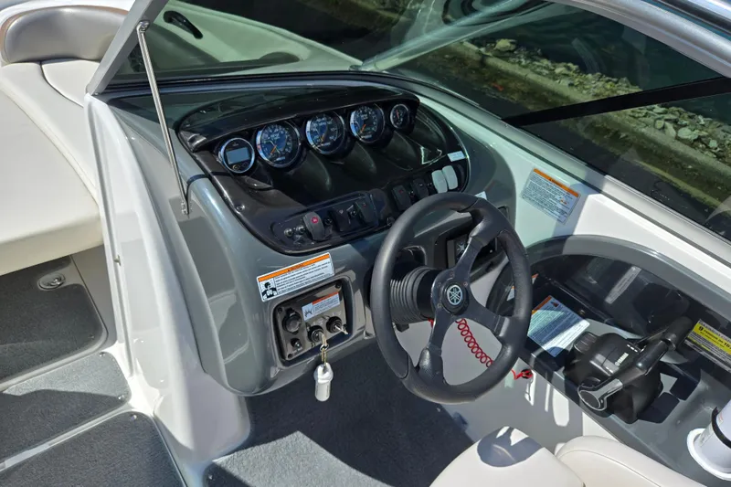 Slide: The Image of 2011 Yamaha Boats AR210 dashboard with steering wheel and control panel. - 12