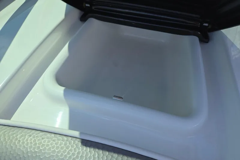 Slide: The Image of Open storage compartment on a 2011 Yamaha Boats AR210. - 16