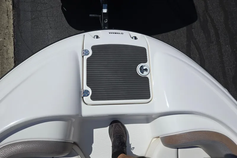 Slide: The Image of 2011 Yamaha AR210 boat deck with footrest and storage hatch. - 18