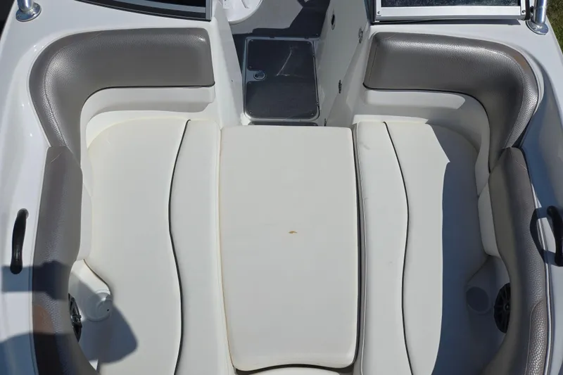 Slide: The Image of 2011 Yamaha Boats AR210 interior seating with gray and white upholstery. - 19