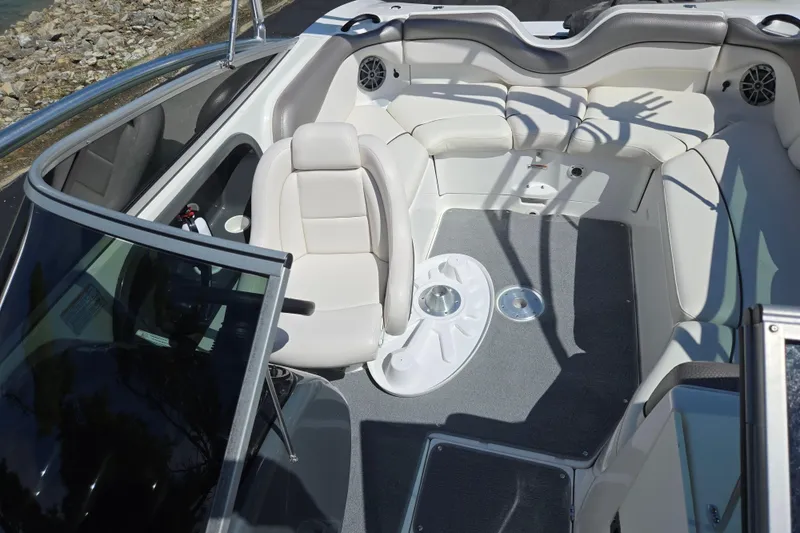 Slide: The Image of 2011 Yamaha Boats AR210 interior with white seating and gray flooring. - 21