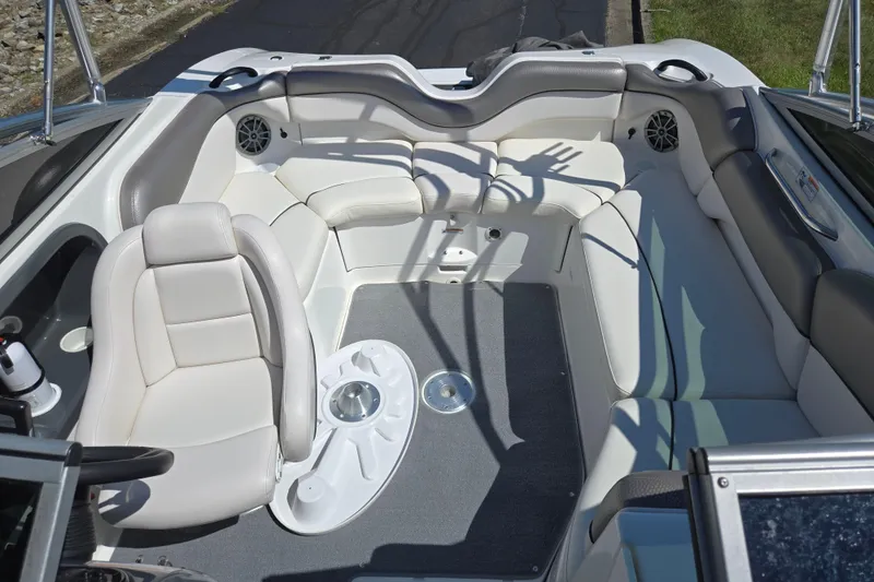 Slide: The Image of 2011 Yamaha Boats AR210 interior with white seating and gray accents. - 22
