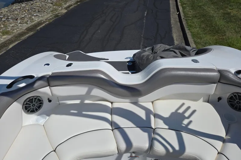 Slide: The Image of 2011 Yamaha Boats AR210 interior with white seating and speaker system. - 23