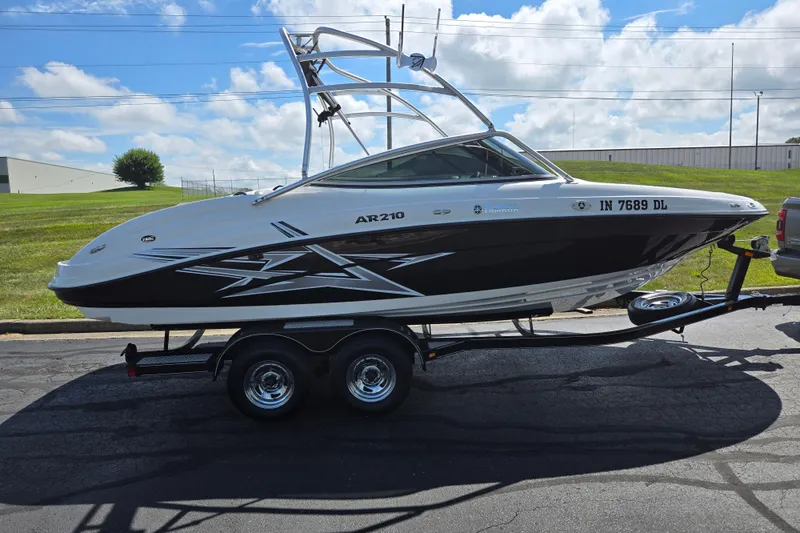 Slide: The Image of 2011 Yamaha Boats AR210 on trailer, parked outdoors under a blue sky. - 4
