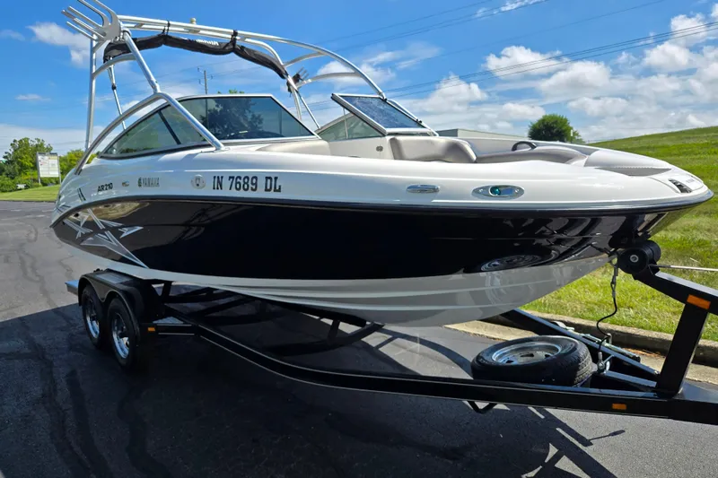 Slide: The Image of 2011 Yamaha Boats AR210 on trailer, parked outdoors under blue sky. - 5