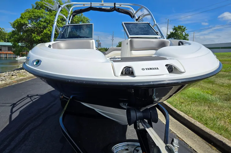 Slide: The Image of 2011 Yamaha AR210 boat on trailer, parked near water, sunny day. - 6