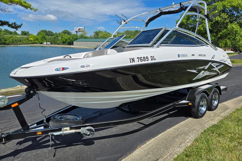 Slide: The Image of 2011 Yamaha AR210 boat on trailer by a lake, sunny day. - 8