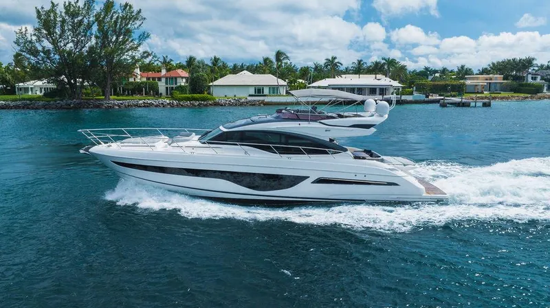 Slide: The Image of Luxury 2022 Princess S66 yacht cruising on a serene waterway. - 0