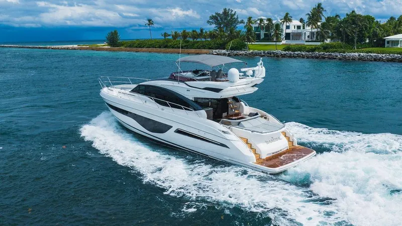 Slide: The Image of Luxurious 2022 Princess S66 yacht cruising in scenic coastal waters. - 1