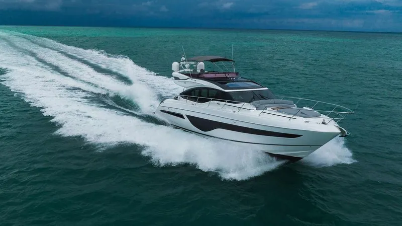 Slide: The Image of 2022 Princess S66 yacht cruising on open sea under cloudy skies. - 11