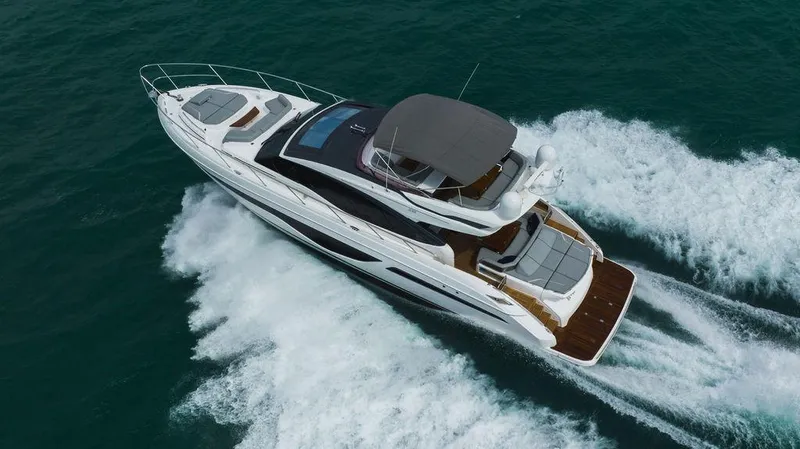 Slide: The Image of 2022 Princess S66 yacht cruising on open water, aerial view. - 12