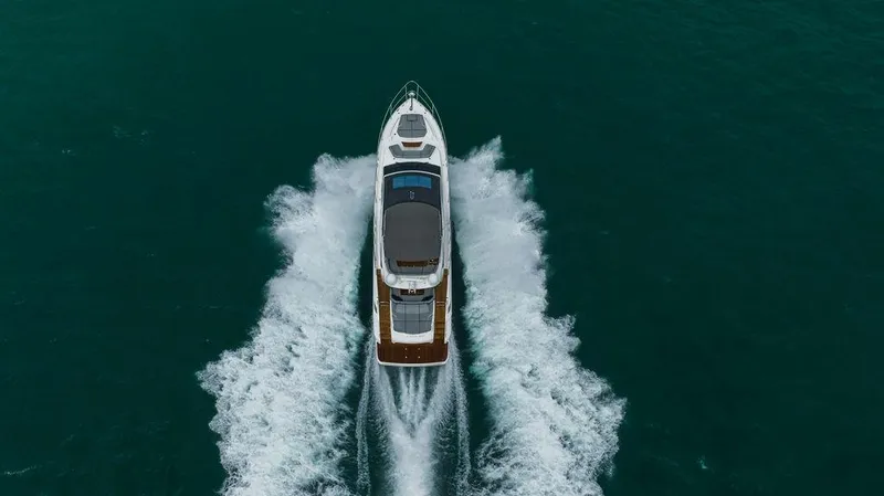 Slide: The Image of 2022 Princess S66 yacht cruising on open water, aerial view. - 13