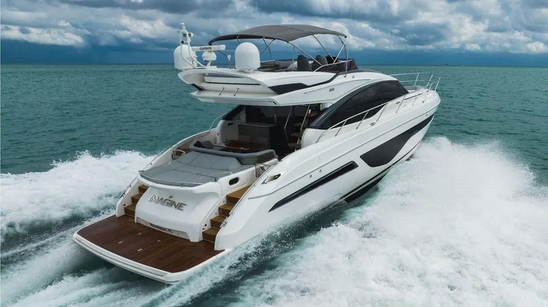 Slide: The Image of 2022 Princess S66 yacht cruising on open water under cloudy skies. - 16